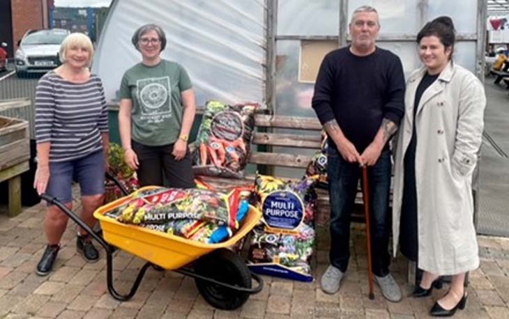 4 people standing in front of the garden centre.